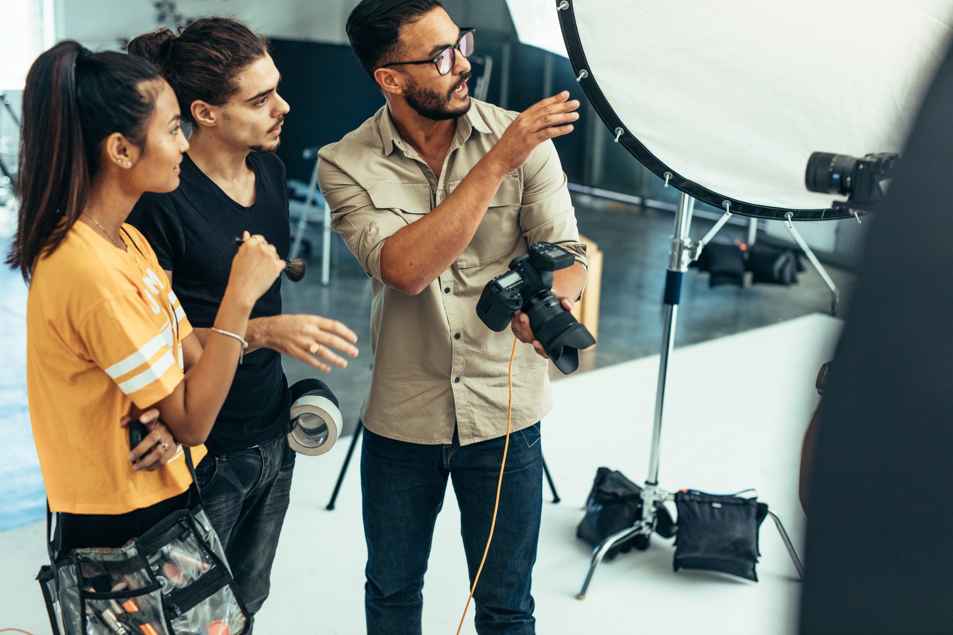 Photographer working with his team during a photo shoot in a studio